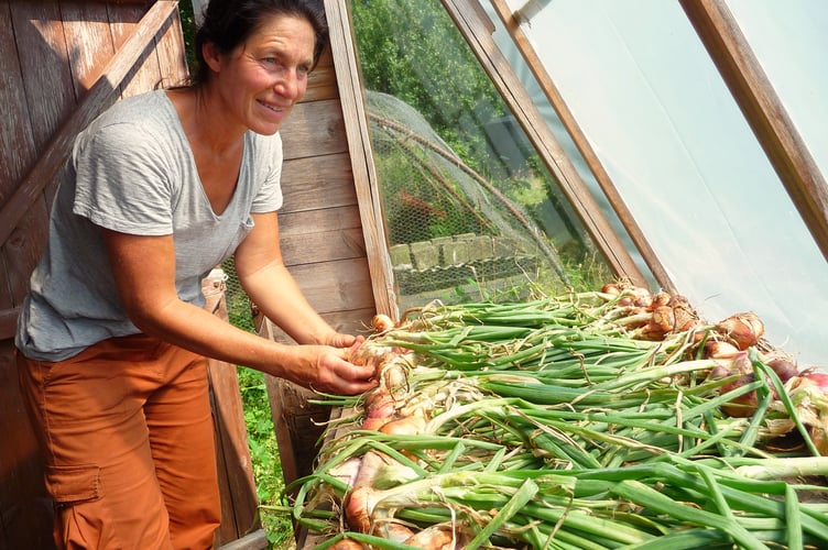 An Orchid Meadows volunteer with some of their fresh produce. Photo: Orchid Meadows