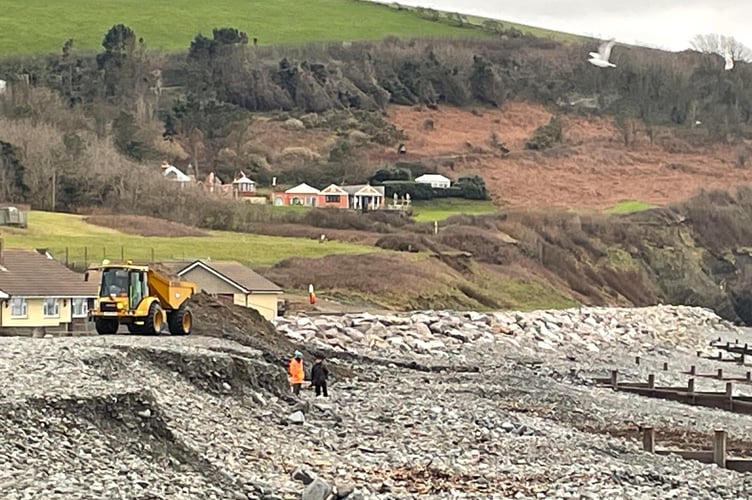 A truck deposits dredged shingle back onto South Beach.