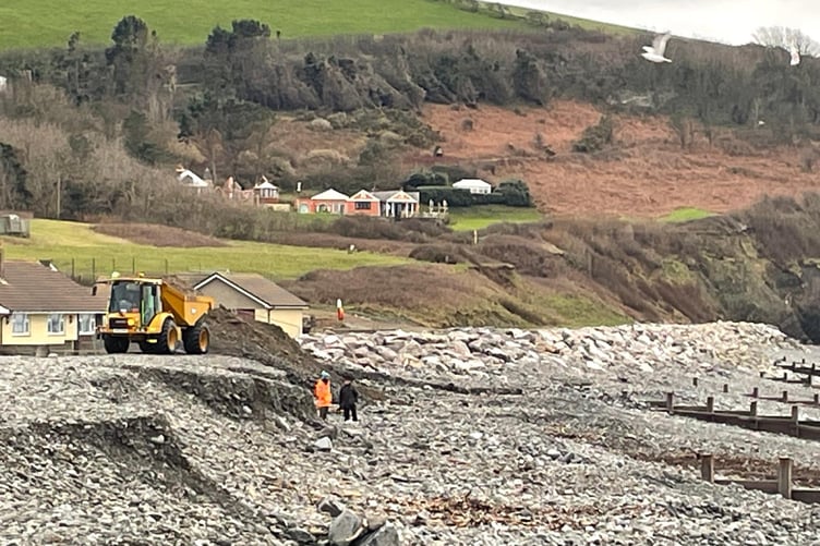 A truck deposits dredged shingle back onto South Beach.
