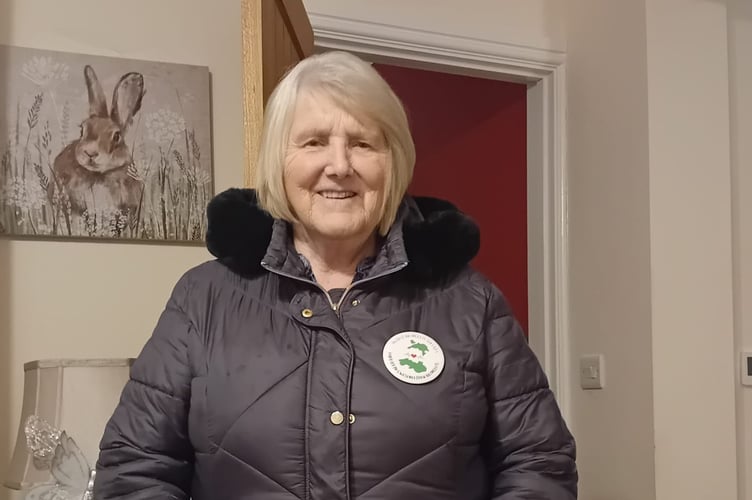 Ruth Davies wearing a badge calling to protect Bronglais' services.