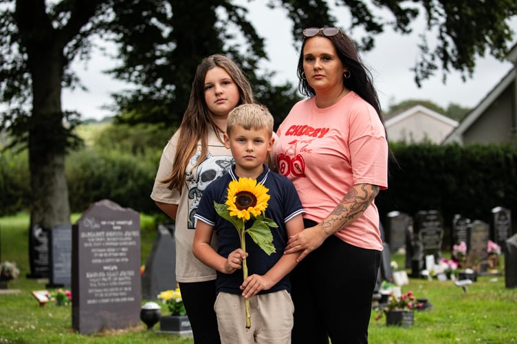 Hazel Louise Jones with her daughter Ameila-Louise Roxanne Davies and son Ethan-Daniel Richard Davies at April's grave in Machynlleth cemetery. July 21 2025. Five-year-old April Jones vanished while playing on her bike just yards from her home in the quiet Welsh town of Machynlleth. What followed was one of the biggest child search operations the UK has ever seen - thousands of volunteers, sniffer dogs, helicopters and a nation holding its breath.