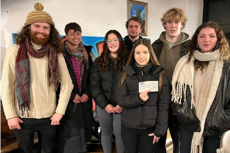 George Horne and Ruby Burgess McCue presenting a £1,000 cheque to Ieuenctid Machynlleth Youth Club - Liam Rickard (assistant youth worker), Beth Clewes (lead youth worker), Martha Price, Kian Williams and Tiahna Waterhouse.