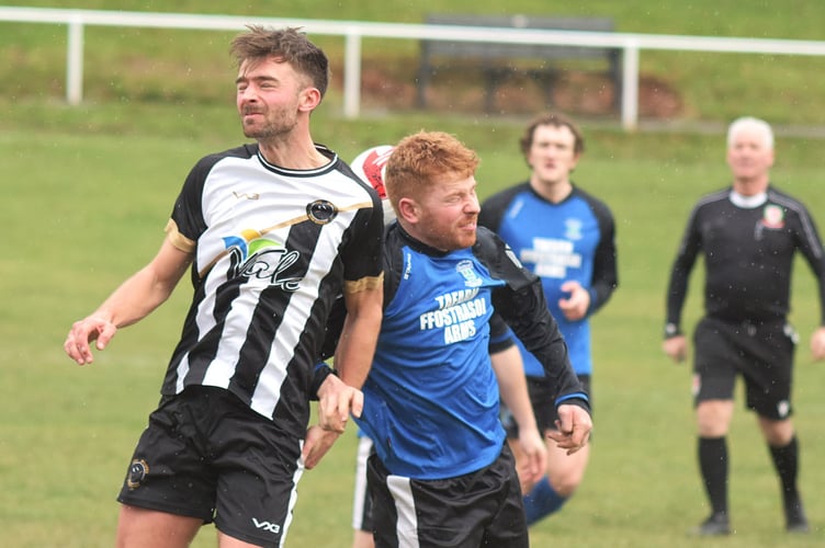 An aerial challenge during Bow Street Reserves' 4-0 defeat against Ffostrasol (Photo: Bev Hemmings)