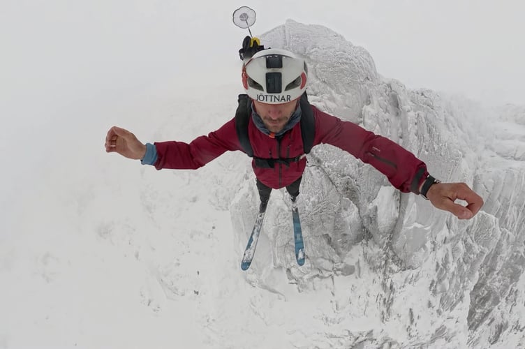 Video grab from incredible footage shows a BASE jumper's record flight off Mount Snowdon. Tim Howell, 36, jumped off the whopping 1,085-metre mountain in Gwynedd, North Wales, on the 18 Jan. Tim, who has been BASE jumping for over 15 years, claims this was the first ever Welsh ski BASE jump on Mount snowdon. Tim, who lives between Martock, Somerset, and Geneva Switzerland, said: "This jump had been lined up for years but we had been waiting for the best snow and wind conditions.