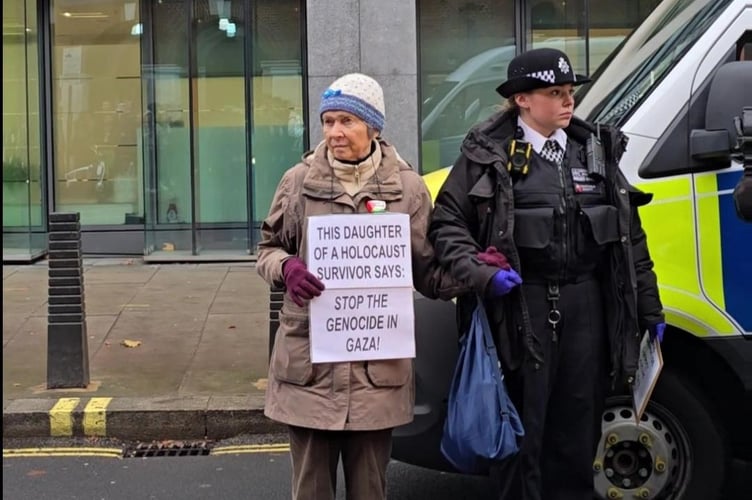 Elizabeth Morley's arrest on 24 November outside the Home Office. The arresting officer had already confiscated the 'I oppose genocide, I support Palestine Action' sign.