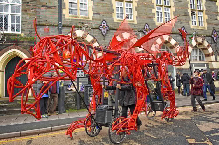 A giant dragon passes the Guildhall in Cardigan