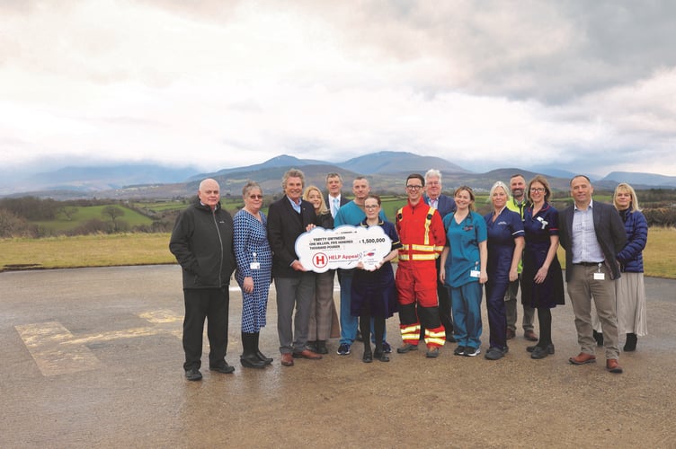 HELP Appeal Chief Executive Robert Bertram presents cheque for £1.5m for new helipads. Photo: BCUHB