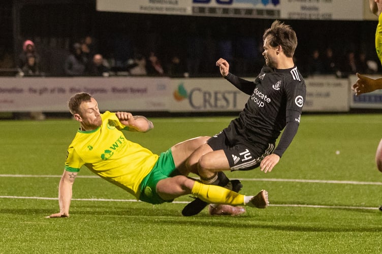 LLANDUDNO, WALES - 13TH MARCH 2026: Caernarfon Town's Phil Mooney fouls Connah's Quay Nomads' Noah Edwards during the JD Cymru Premier fixture between Caernarfon Town and Connah's Quay Nomads at the Go Goodwins Stadium, Llandudno. 13th of March, Llandudno, Wales (Pic by Nik Mesney/FAW)