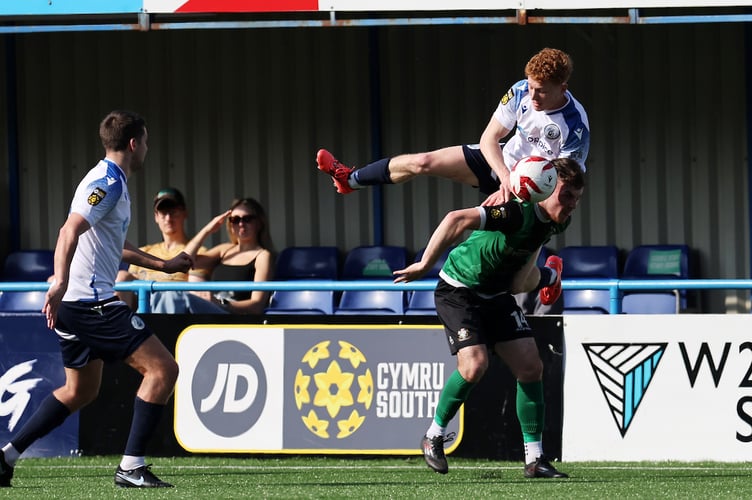 CLYDACH VALLEY, WALES - 21st MARCH 2026: Dylan Edwards of Cambrian Utd falls over Owain Evans of Aberystwyth Town during the 2025/26 JD Cymru South fixture between Cambrian United vs Aberystwyth Town at The M & P Group 3G in Clydach Vale, Rhondda, South Wales. (Pic By Andrew Orchard/FAW)