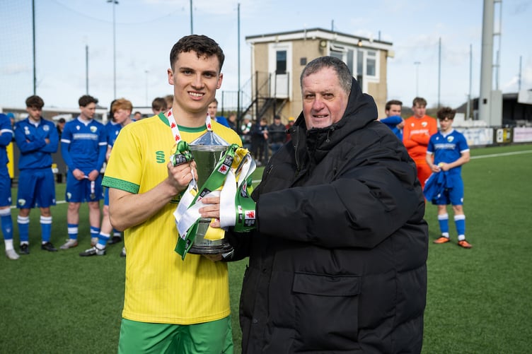 LLANDUDNO, WALES - 05 APRIL 2026: Caron Williams of Caernarfon Town receives the trophy after winning the FAW Youth Cup Final between The New Saints and Caernarfon Town at Go Goodwins Stadium in Llandudno. (Pic by Craig Thomas/FAW)