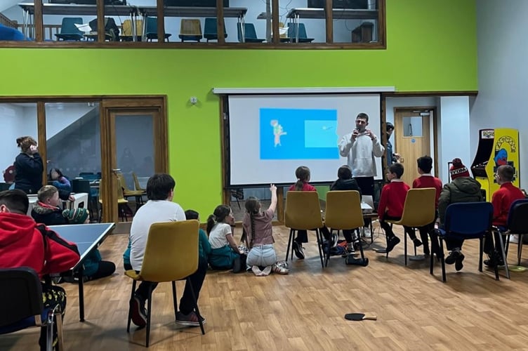 Joseff Edwards speaking to young people during a CIC youth club session at the new venue, Yr Aelwyd.