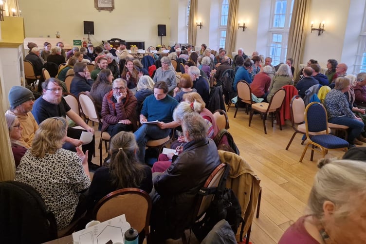 People broke out into groups to discuss which questions to ask candidates.