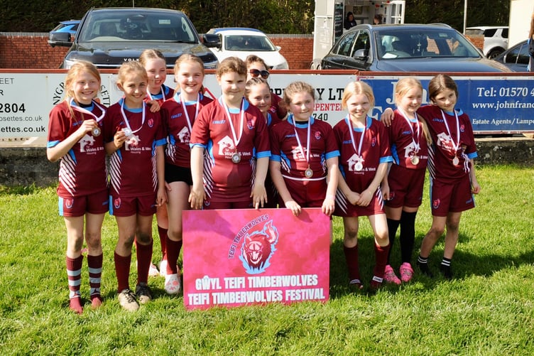 The girls donning their medals