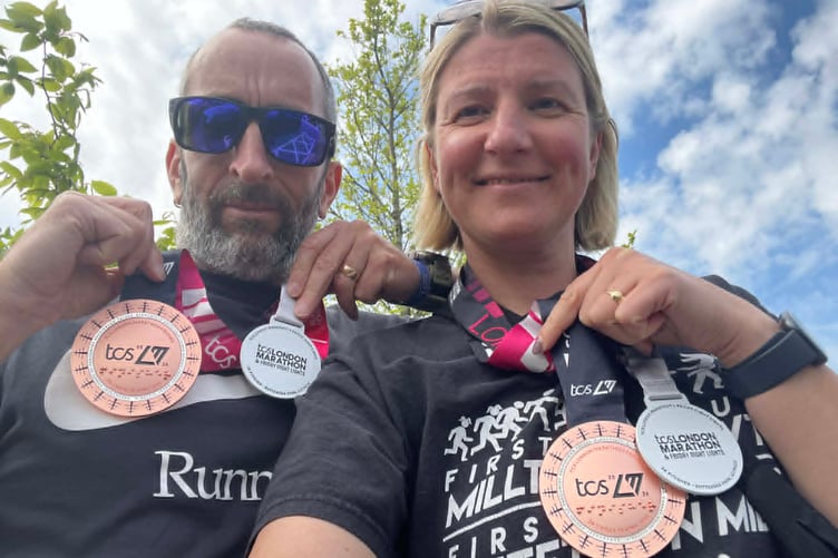 Edd and Lina show off their marathon medals