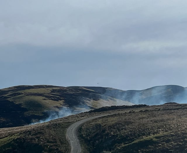 Rain and helicopters bring wildfires under control