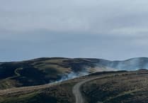Rain and helicopters bring wildfires under control