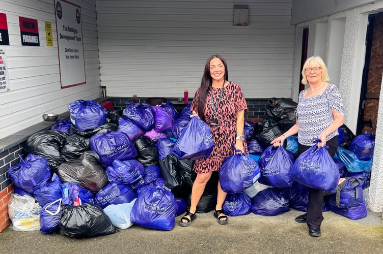 Kristy Roberts and Maxine Lyons and the bags collected for The Big Clothes Throw