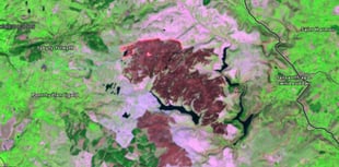What is causing the unprecedented scale of Wales' wildfires?