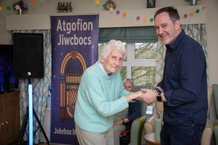 Emyr Gibson, creative practitioner at Pendine Park's Bryn Seiont Newydd care home, with resident Pamela Barker. Photo: Mandy Jones