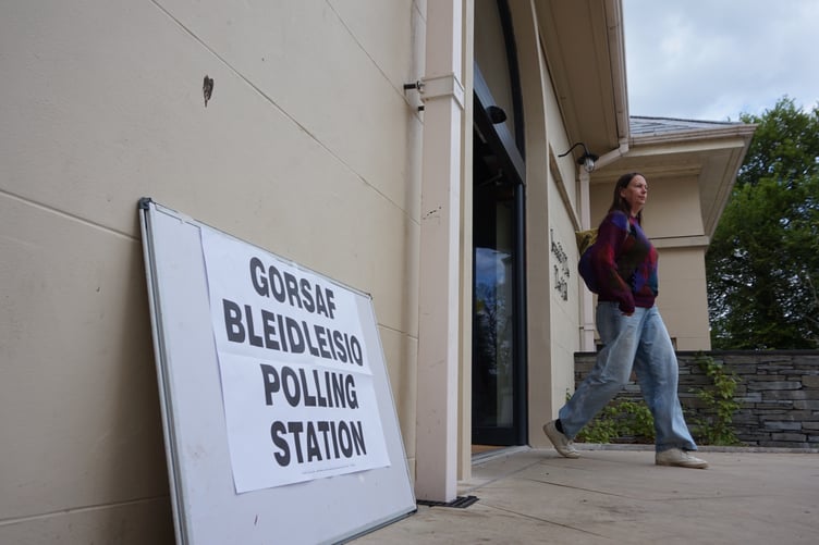 Electors casting their votes this afternoon at the polling station at Y Plas town hall in Machynlleth.