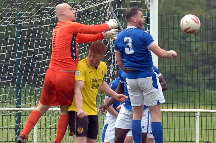 Dolgellau goalscorer Gerwyn Williams is crowded out in the penalty area (Photo: Rod Davies)