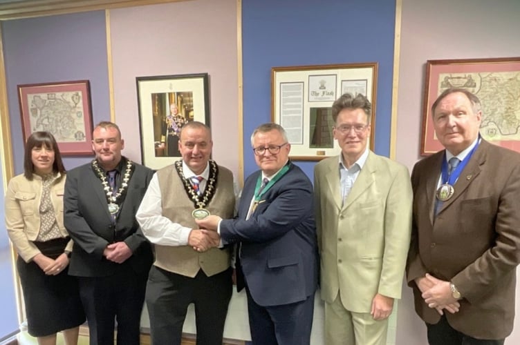 The Powys council chains of office are handed over to new chairman Cllr Geoff Morgan (centre left) from outgoing chairman Cllr Bill Powell (centre right).