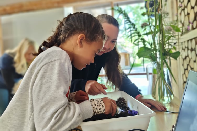 Girl exploring soil on an open day at CAT