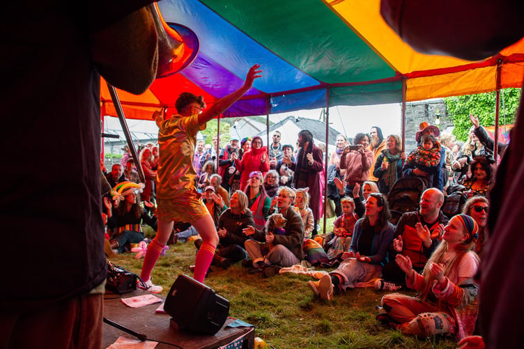 The Machynlleth Thunder and Lightning Women and Non-binary Football Team Band playing to a crowd at the rainbow stage.