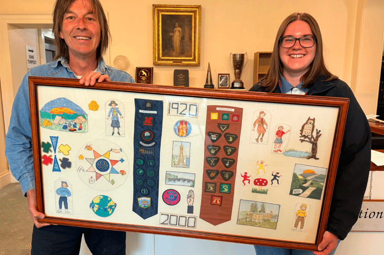 Heulwen Medi, Leader at Machynlleth Guides, presenting the frame to Cllr Jeremy Paige, Mayor of Machynlleth.
