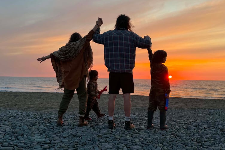 On the beach with his family, Louise, Aedon, and Khenan