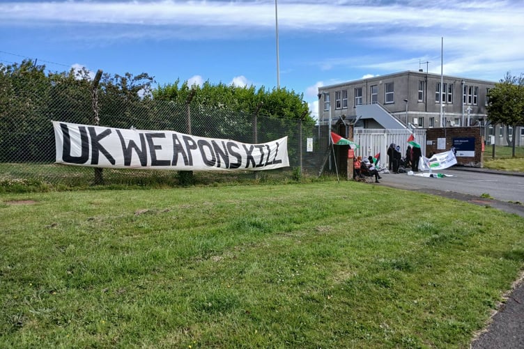 Banners were placed along the perimeter of MOD Aberporth, with one stating 'UK weapons kill'.