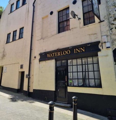 Plans to create 13 self-contained flats inside a former Bangor pub and vacant High Street shops have been approved by Gwynedd County Council.