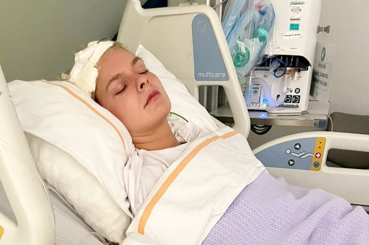 Mez Olivia, 30, from Lampeter, Wales, in hospital after suffering from a brain haemorrhage while working in Dubai. // A woman who collapsed without warning while working in Dubai had to relearn how to walk after suffering a life-threatening stroke and brain bleed that left her unable to feel the right side of her body. Mez Olivia, 30, from Lampeter, Wales, was living in Dubai and working as a costume character animator and dancer when her life changed in October 16, 2021. The social media manager says she had no symptoms whatsoever before collapsing at work and waking up days later in intensive care. Doctors discovered Mez had suffered a brain haemorrhage caused by an arteriovenous malformation (AVM) - a tangle of abnormal blood vessels in the brain. She spent 11 days in intensive care and underwent emergency treatment after doctors warned her family that without intervention she would die. After stabilising in Dubai, Mez was flown back to the UK in December 2021 as her insurance coverage was running out.