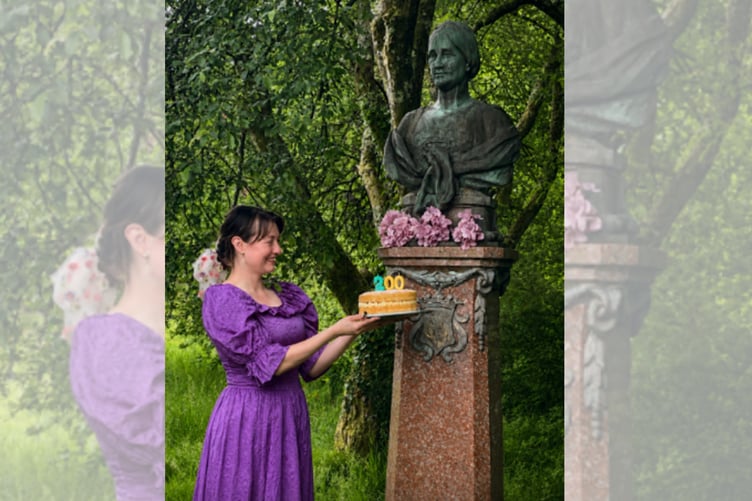 A Machynlleth librarian presents the Mother Londonderry statue with a 200th birthday cake. Photo: Machynlleth Library