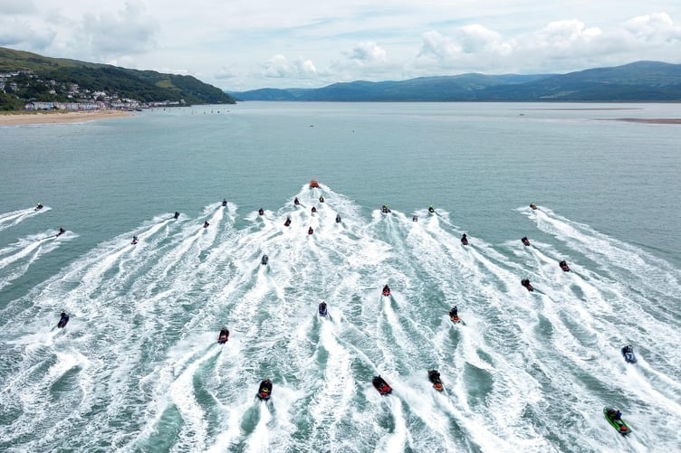 Aberdyfi RNLI Lifeboat escorts the charity jet ski rideout into the estuary. Photo: Andy O'Regan