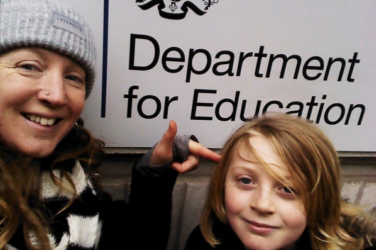 Hannah Johns and her son outside the Department of Education in London.