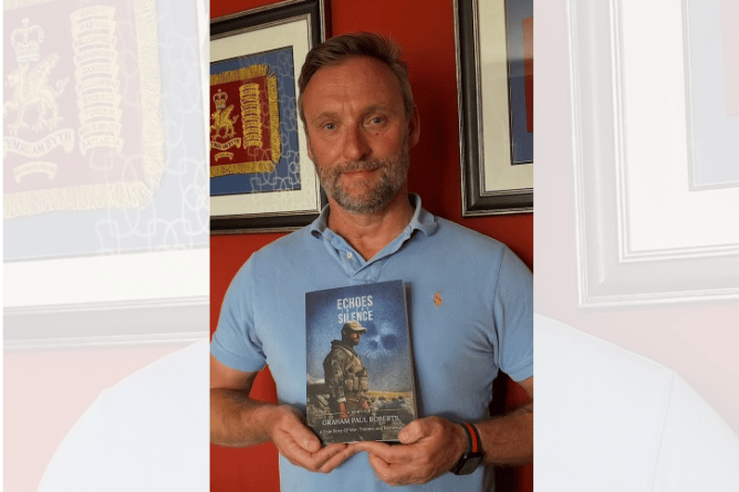 Graham Paul Roberts with his memoir, 'Echoes in the Silence'