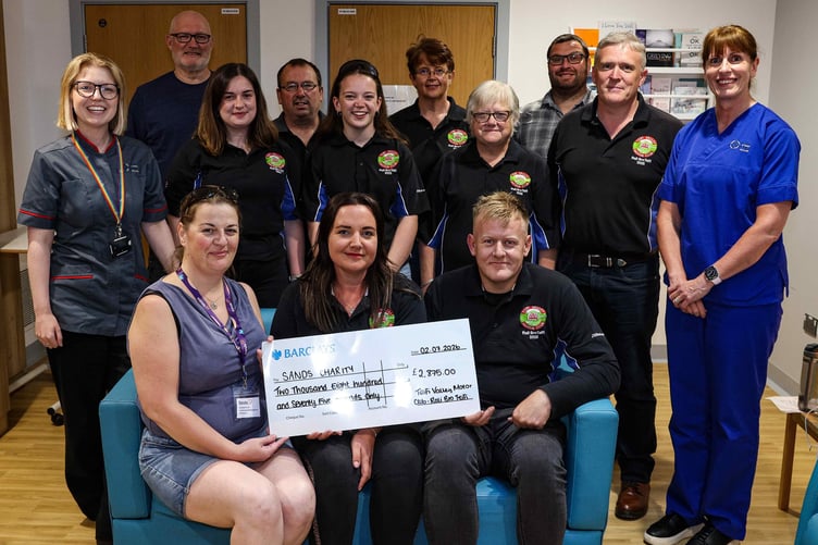 The Sands team receive their donation