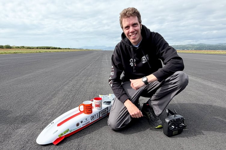 Stephen Wallis, 44,, with his remote control car, The Mach Reaper, which he drove at over 250mph. Photo: Stephen Wallis / SWNS