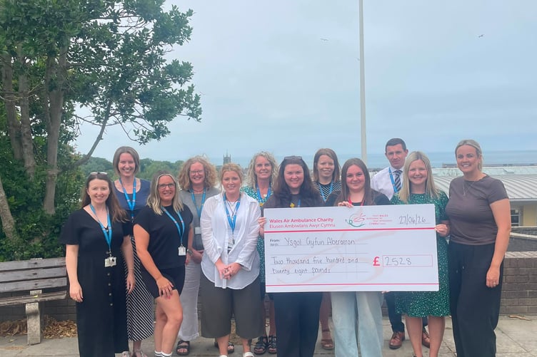 Emily Bell with the Staff from Ysgol Gyfun Aberaeron during the cheque presentation.