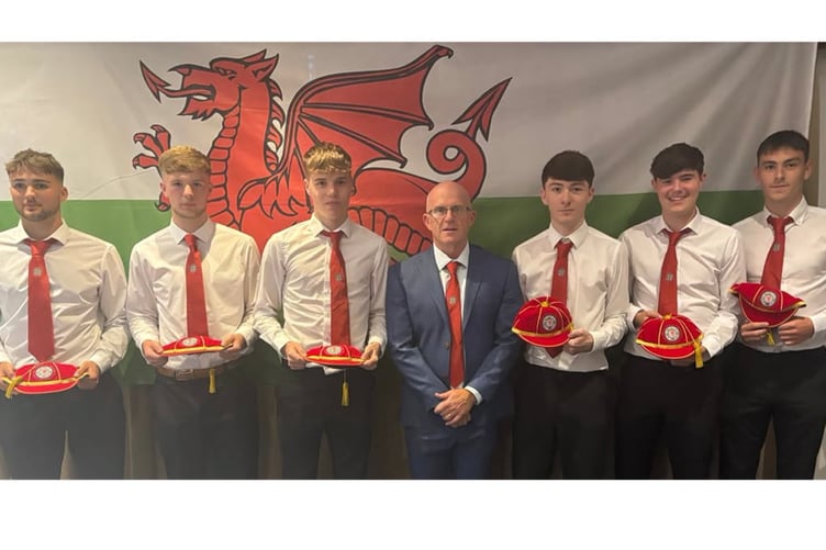 The Grŵp Llandrillo Menai players with their international caps and manager Marc Lloyd Williams