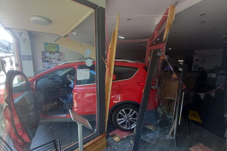 A red Ford car reversed into a shop in Aberystwyth town centre on Wednesday 22 July. Photo: Porthi Aber