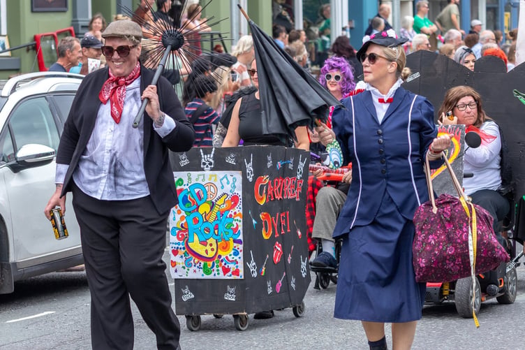 Mary Poppins joined the parade ahead of a rocking group from Cartef Dyfi.