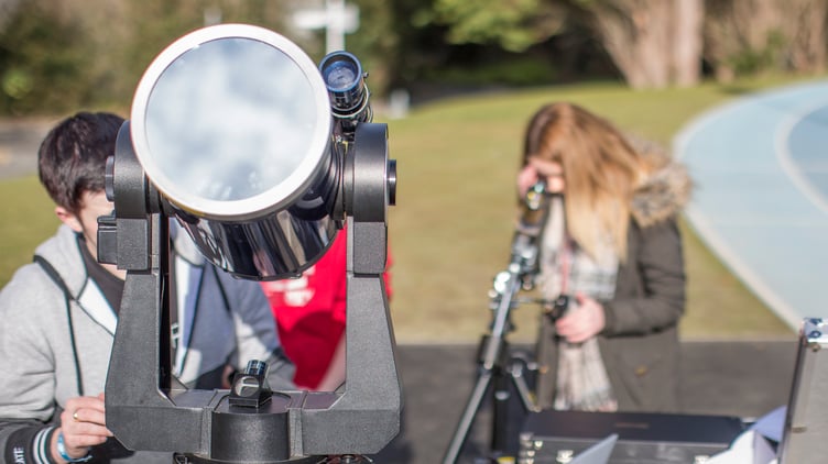 Physics students observing and photographing the sun with the use of specialised telescopes and filters