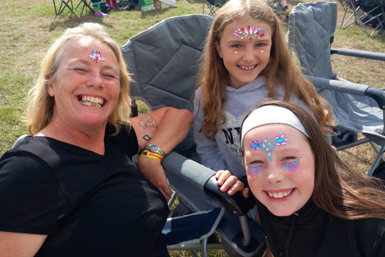 The fun, friendly atmosphere of the festival even brings strangers together; Christie Gorman, Jenna McNicholls Vale and Phoebe Pearson met for the first time today over a love of festival gems. Photo: Julie McNicholls Vale