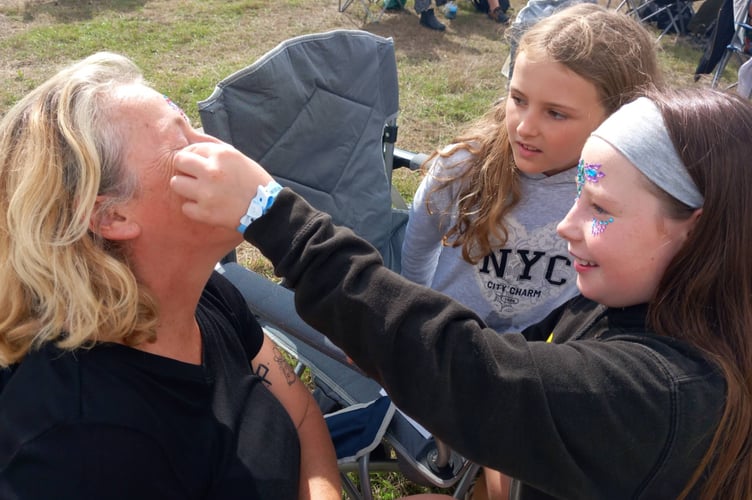 The fun, friendly atmosphere of the festival even brings strangers together; Christie Gorman, Jenna McNicholls Vale and Phoebe Pearson met for the first time today over a love of festival gems. Photo: Julie McNicholls Vale