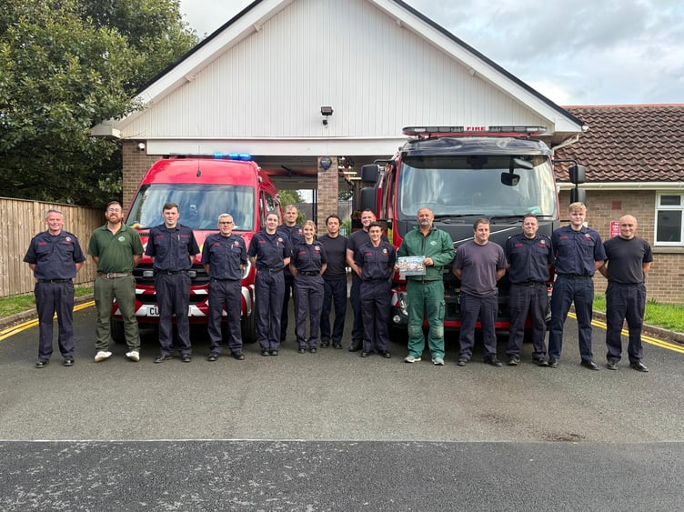 Garth Holiday Park representatives with members of the local fire service following the £800 fundraising donation