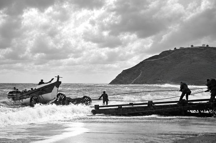 A lifeboat is launched into the rough waters of Aberystwyth in 1896.