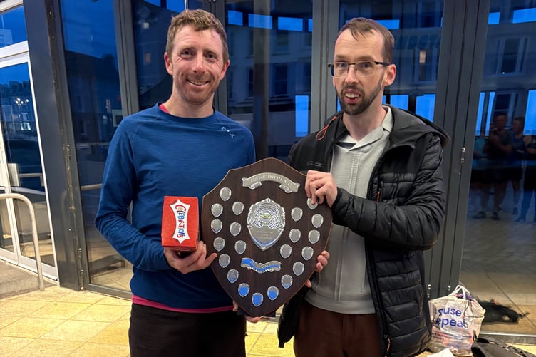 Ian Evans presenting the trophy to Owain Schiavone