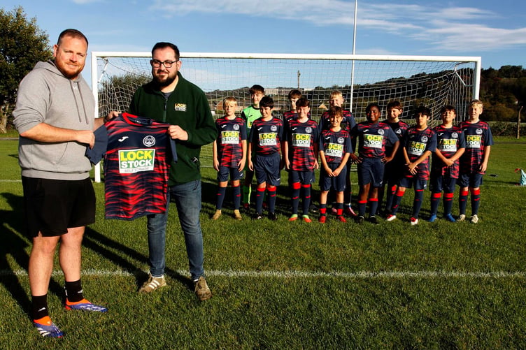 Ollie Beech of Lock Stock Storage presenting new kit to Daniel Owen manager of Penparcau under 13s